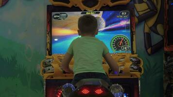 Kid having fun with racing simulator video