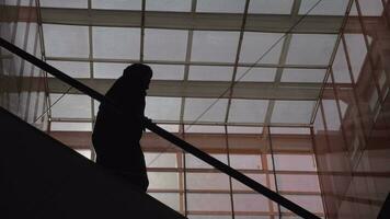 People silhouettes on escalator in shopping centre video