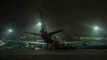 Timelapse of unloading arrived Thai airplane at winter night Domodedovo, Moscow video