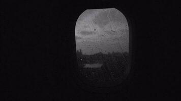 Flying by plane in rainy evening, view through the illuminator video