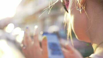 Woman surfing internet on mobile in city street video