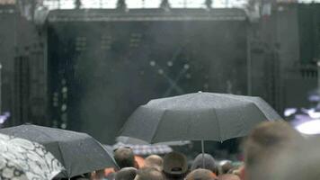 A slow motion of a rainy day at an open air concert video