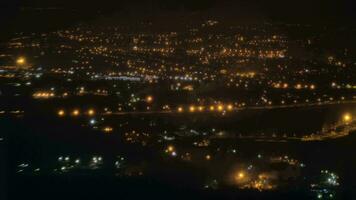 Flying by plane over Paris illuminated at night, France video