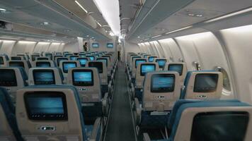 Airplane cabin with aisle and empty seats of economy class video