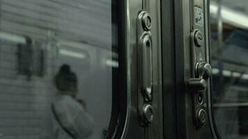 Departing subway train, view from inside through closed doors video