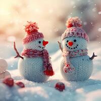 two snowmen are standing in the snow with a red hat and scarf photo