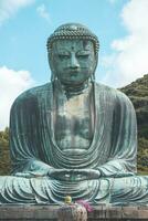 The great blue buddha statue Kamakura Daibutsu at Kotoku in shrine temple in Kamakura,Kanagawa, Japan photo