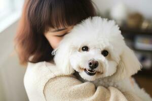 portrait of woman hugging cute bichon frise dog. pet concept photo