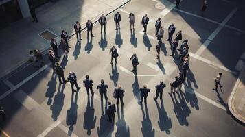 Bird's eye view of business professionals forming a circle in a city intersection photo