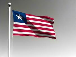 Liberia national flag waving on gray background photo