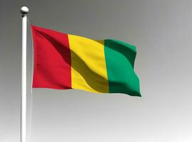 Guinea national flag waving on gray background photo