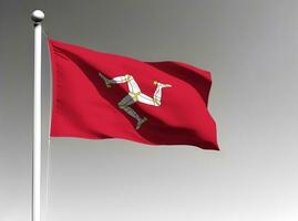 Isle of Man national flag waving on gray background photo