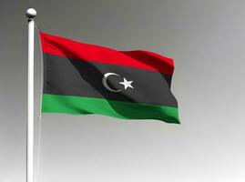 Libya national flag waving on gray background photo