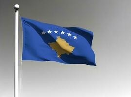 Kosovo national flag waving on gray background photo