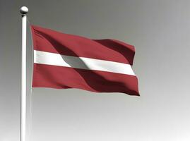 Latvia national flag waving on gray background photo