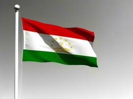 Tajikistan national flag waving on gray background photo