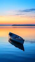 Peaceful dawn over a calm lake with a solitary rowing boat in the distance photo