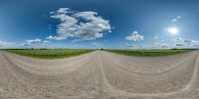 360 hdri panorama on gravel road with clouds and sun on blue sky in equirectangular spherical  seamless projection, use as sky replacement in drone panoramas, game development sky dome or VR content photo