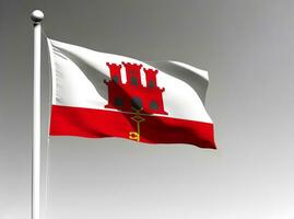 Gibraltar national flag waving on gray background photo