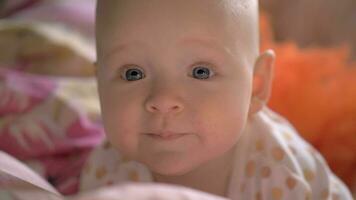 Portrait of baby girl with big blue smiling eyes video