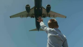 Child waving hand to the plane overhead video