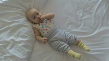 Quiet baby girl on the bed at home video