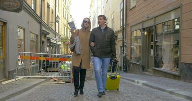 Young travelers with map and bag searching the way in city video