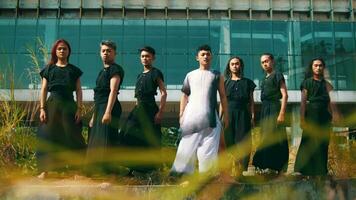 a group of Asian men standing in front of an old building and enjoying the cool breeze video