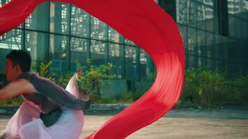 an Asian man is waving a red cloth with his hand while in an old building video