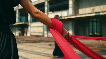 a group of Asian men tied a man with a red rope with his friends in an old building video