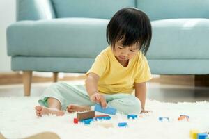 Happy Asia children play and learn toy blocks.family is happy and excited in the house. daughter having fun spending time, Activity, development, IQ, EQ, meditation, brain, muscles, essential skills. photo