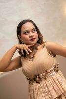 an Asian woman is posing beautifully while wearing makeup and an elegant party dress at a hotel photo