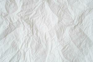 Wrinkled or crumpled white stencil paper or tissue after use in toilet or restroom with large copy space used for background texture in decorative art work. photo