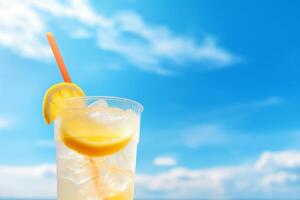 Bright Summer Image of Iced Lemonade in Glass with Lemon Slice and Straw photo