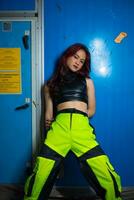 an Asian man with a pretty face and long red hair wears green pants photo