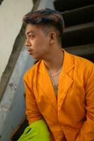 an Asian man in a yellow suit is standing on a broken elevator photo