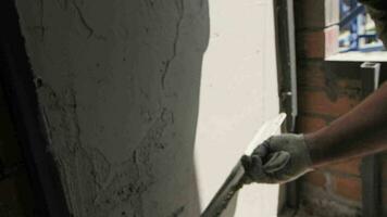 worker at a construction site plasters a wall with a spatula video