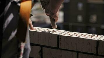 A worker builds a wall of a house video