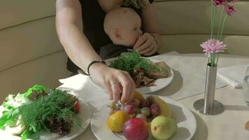 Mother with baby daughter having meal in cafe video