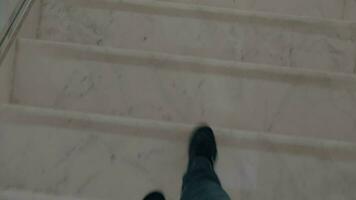 Male feet going down a marble steps video