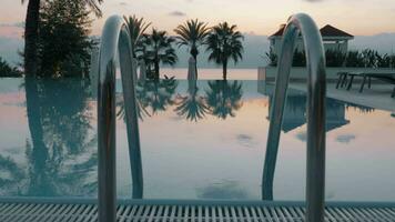 Steadicam shot of an empty swimming pool and the evening scenery video