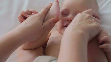 A woman playing with baby daughter's feet video