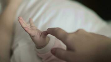 Maternal love Mother touching baby hand video