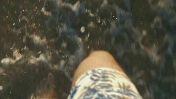 Barefoot man walking in sea waves washing shore Summer vacation on coast video