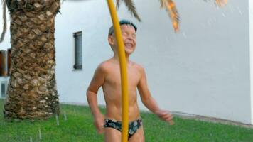 Child and mom having fun time with water in the yard video