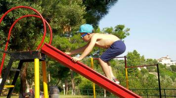 Outdoor children activities Kid climbing slider at playground video