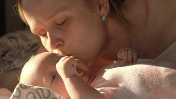 Loving mother kissing baby video