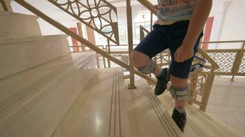 Kid with foot drop system walking upstairs video