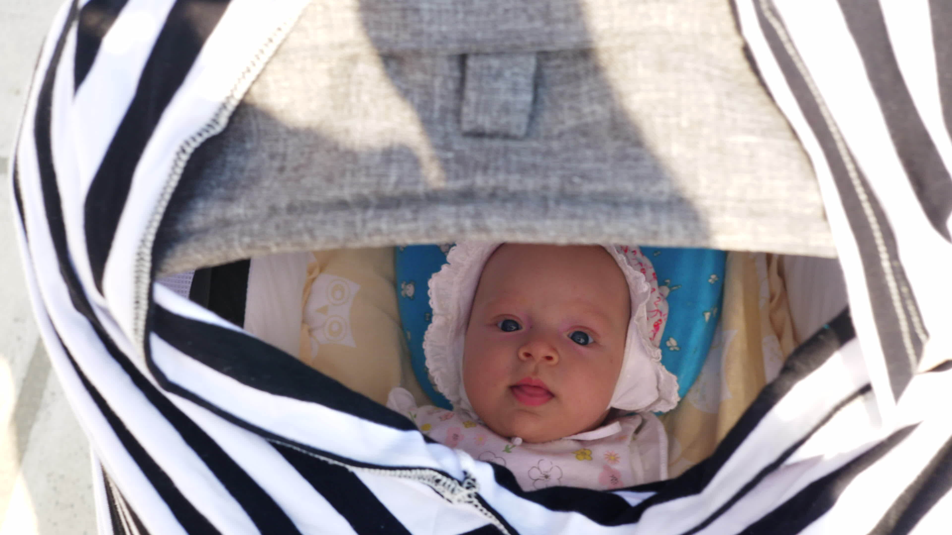 Lulling baby girl in pram 28773660 Stock Video at Vecteezy