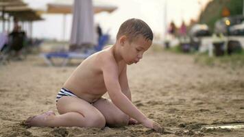 Kid playing with sand the at beach during summer vacation video